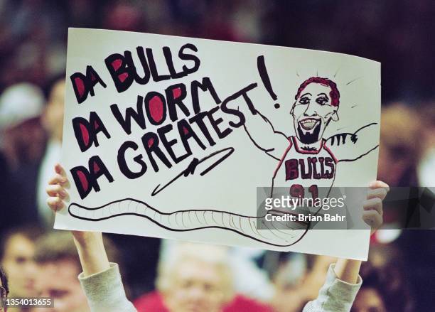 Fan of Dennis Rodman of the Chicago Bulls holds up a banner with a caricature cartoon of the player during the NBA Central Division basketball game...