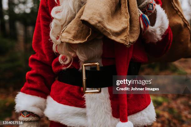 mid section of person wearing santa costume - johner christmas bildbanksfoton och bilder