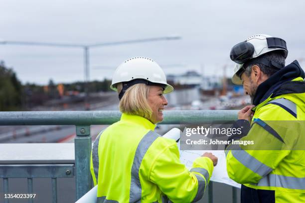people talking on building site - road construction stock pictures, royalty-free photos & images