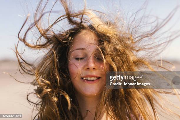 portrait of teenage girl with messy hair - haar stockfoto's en -beelden