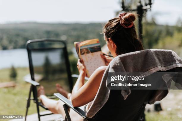 woman doing crosswords - crosswords stock pictures, royalty-free photos & images