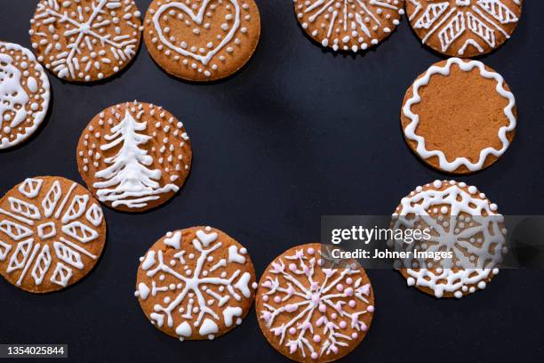 christmas cookies with icing on black background - johner christmas bildbanksfoton och bilder