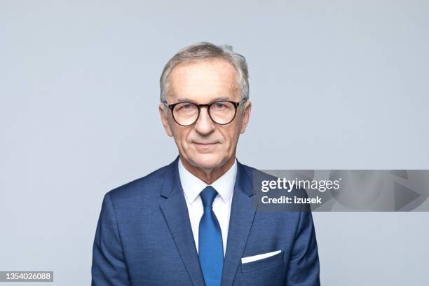 headshot of confident senior businessman - blue suit stock pictures, royalty-free photos & images