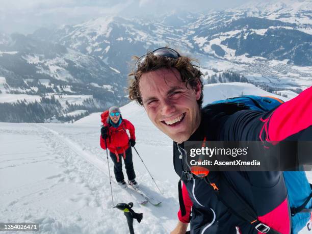 portrait of backcountry skiing couple, smiling - telemark skiing stock pictures, royalty-free photos & images