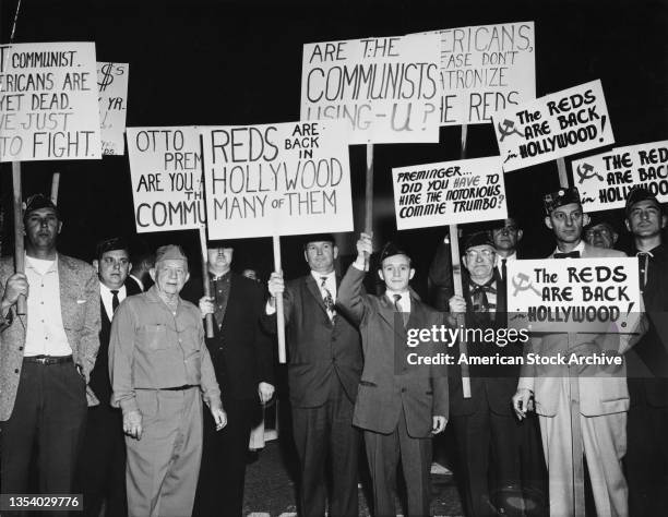 Group of protesters demonstrate holding placards against Communist sympathizers outside the Fox Wilshire Theatre in occasion of the premiere of film...