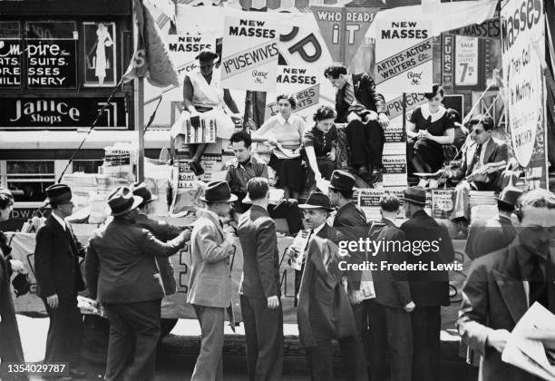 Truckload of demonstrators giving away pamphlets of American Marxist magazine 'New Masses' at the May Day Parade. Circa 1940.