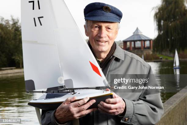 model boat owner proud of his craft - only senior men 個照片及圖片檔