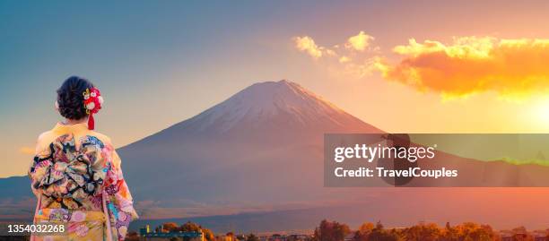 travel mount fuji of japan. famous landmarks of the asian. asian woman wearing japanese traditional kimono at fuji mountain. sunset at kawaguchiko lake in japan. - kimono winter stock pictures, royalty-free photos & images