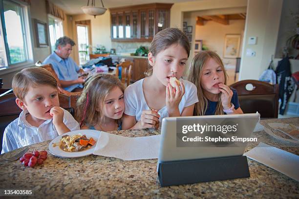 family at kitchen counter with tablet computer - san diego house stock pictures, royalty-free photos & images
