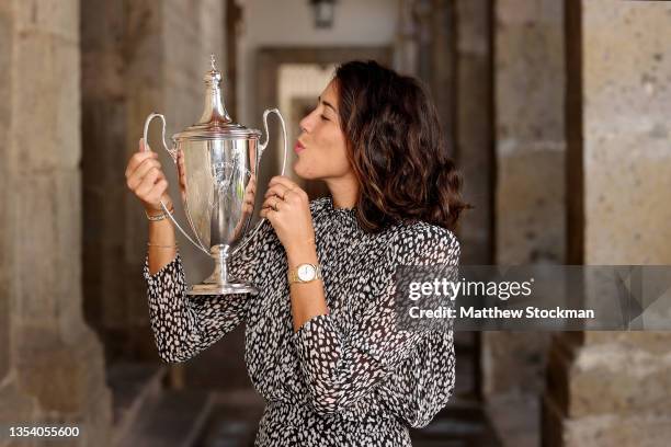 Garbiñe Muguruza of Spain poses with the Billie Jean King trophy at Hospicio Cabañas on November 18, 2021 in Guadalajara, Mexico. Muguruza defeated...