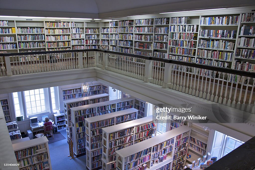 Balcony and lower level of library with books.