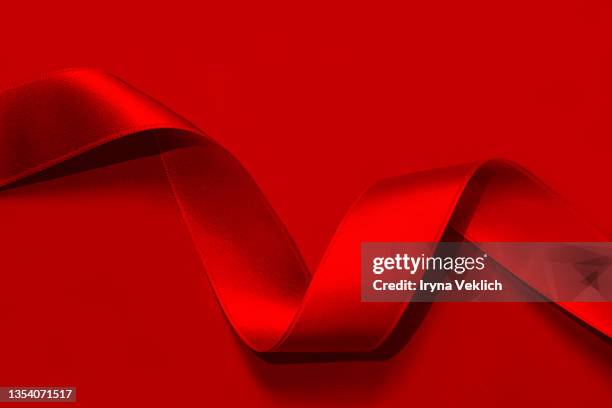 holiday background made from curly red satin ribbon. - red silk stock pictures, royalty-free photos & images