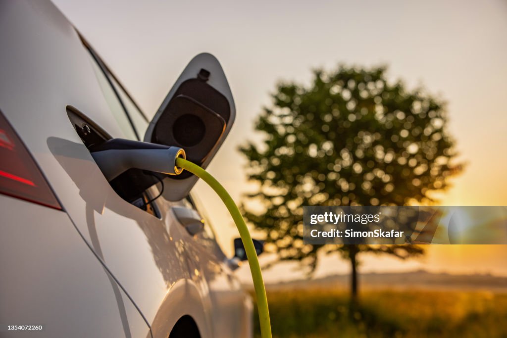 Charging an electric car on rural field