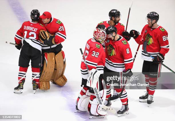 Marc-Andre Fleury of the Chicago Blackhawks congratulates Alex DeBrincat as Dominik Kubalik congratulates Kevin Lankinen and Jujhar Khaira...