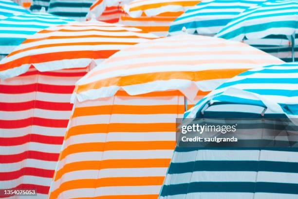 full frame shot of striped beach tents - biarritz stock-fotos und bilder