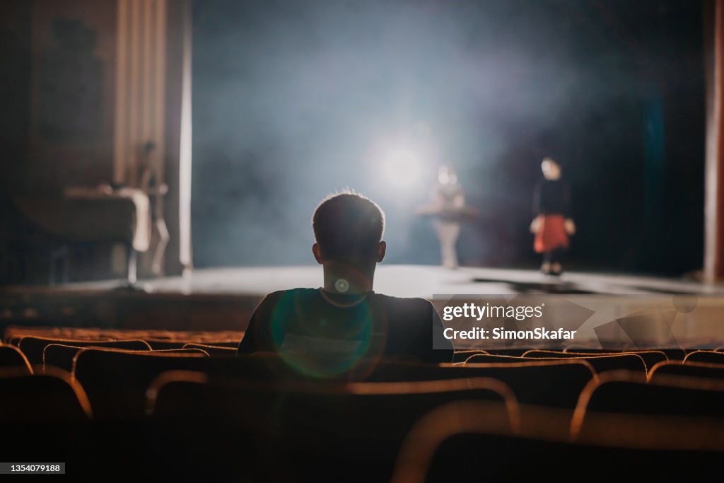One spectator watching the rehearsal of ballet dancer on stage