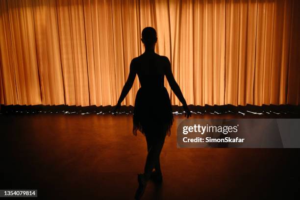 rear view of ballet dancer waiting behind curtain on backstage - behind the curtain stock pictures, royalty-free photos & images