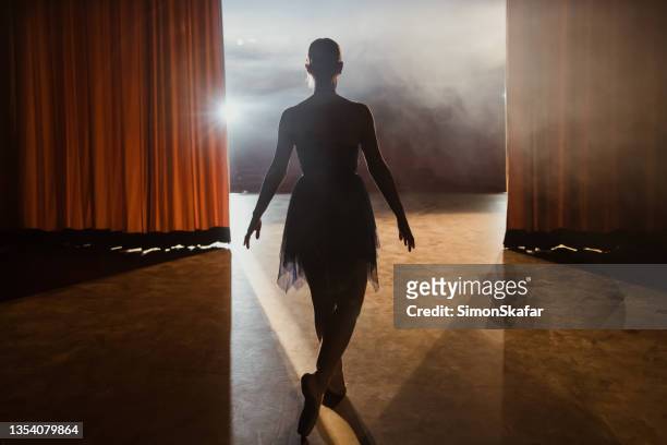 rear view of ballerina walks into the stage after the curtains open - backstage stockfoto's en -beelden
