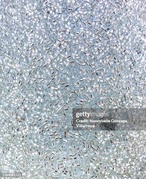 silver sequins on a light blue fabric - sequin stock pictures, royalty-free photos & images
