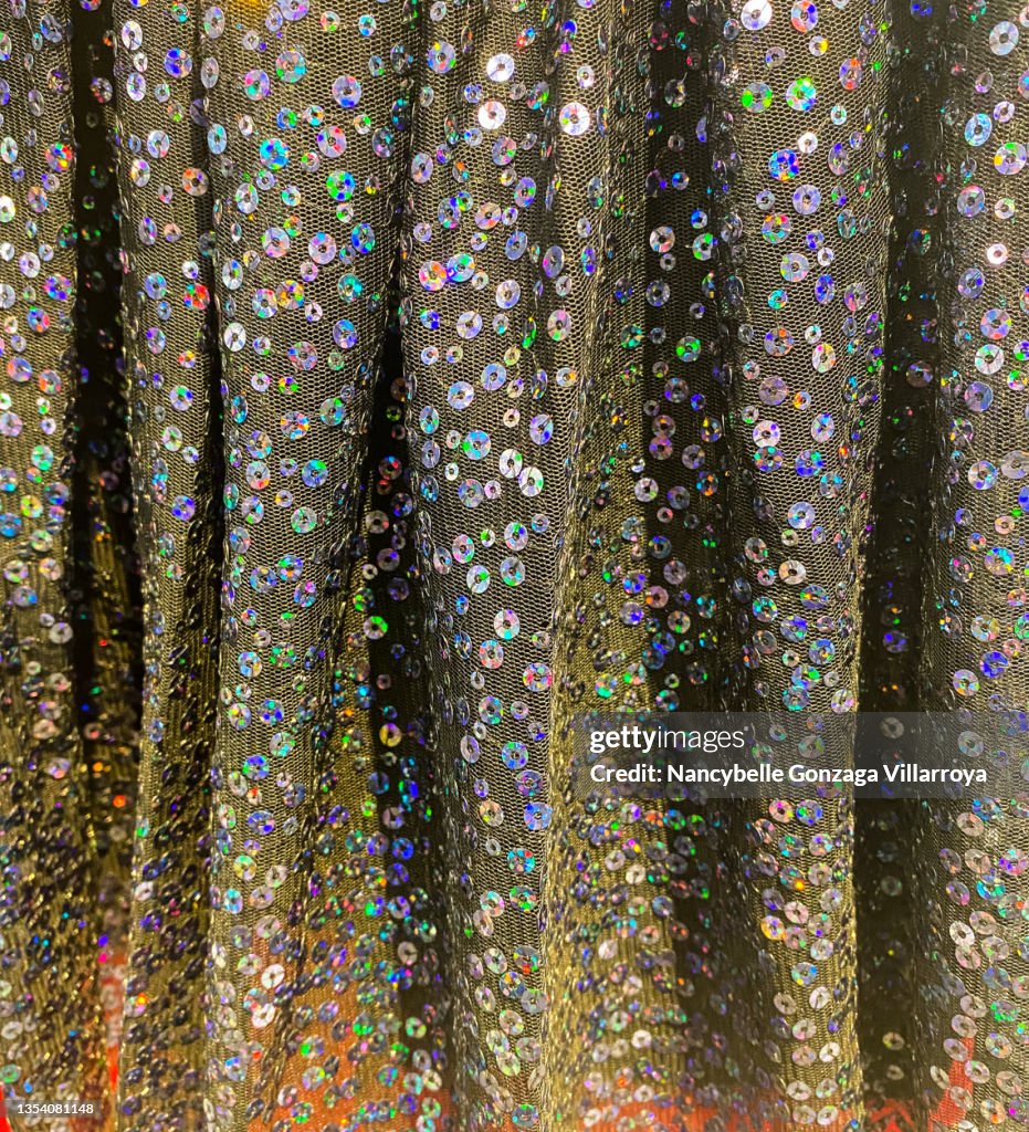 Multi coloured Sequins on a Gray Tulle Fabric