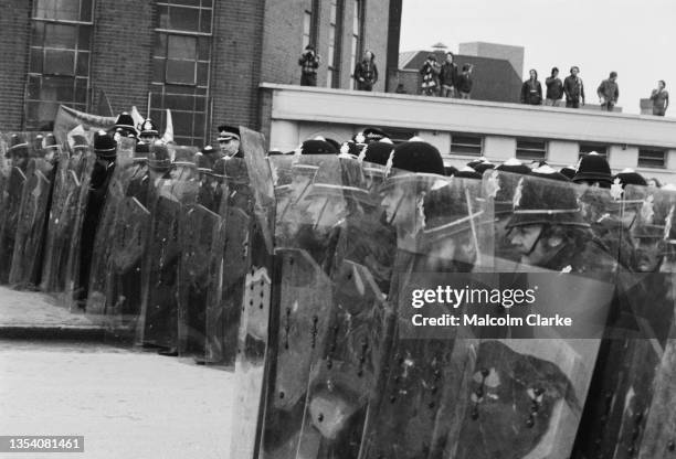 Police form a wall with riot shields during violent clashes with demonstrators against the neo-fascist National Front party outside Digbeth Civic...