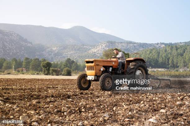 plowing the field - plowed field stock pictures, royalty-free photos & images