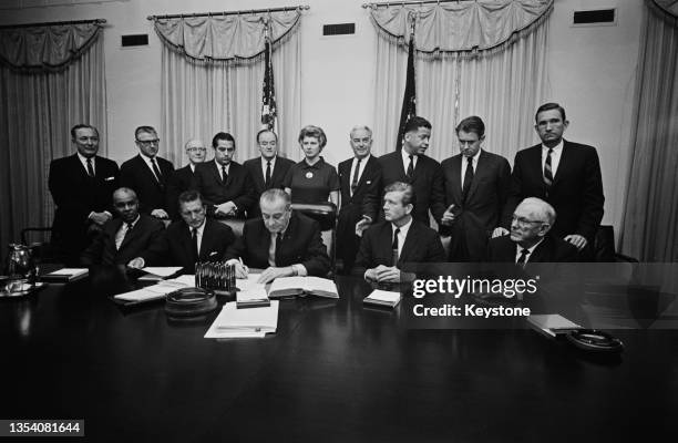 President Lyndon B. Johnson at the first meeting of the National Advisory Commission on Civil Disorders, also known as the Kerner Commission, in the...