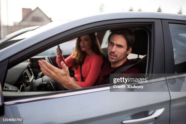 photo of a young couple in a car, arguing with someone - intrusion stock pictures, royalty-free photos & images