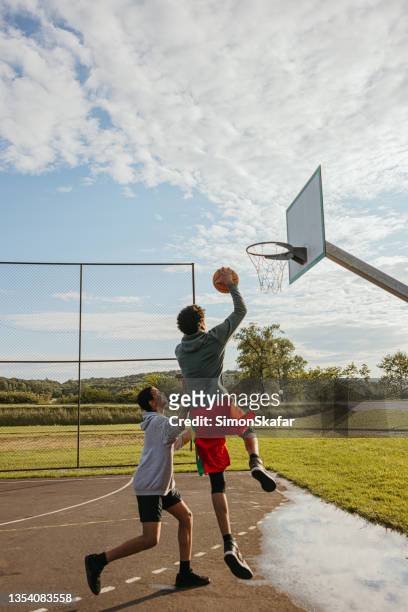 two players practicing basketball game - boys basketball stock pictures, royalty-free photos & images