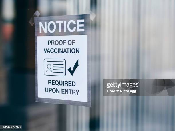 business wtih vaccine mandate sign - mandate stock pictures, royalty-free photos & images