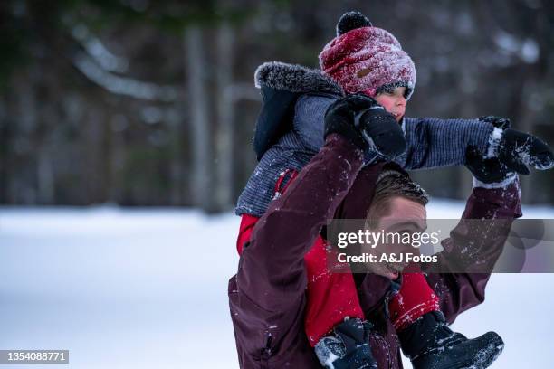 family playing outside during winter. - uncle nephew stock pictures, royalty-free photos & images