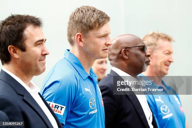 Former North Melbourne coach Brad Scott, Jack Ziebell, North Melbourne CEO, Ben Amarfio, and David Noble, Senior Coach of the Kangaroos look on...