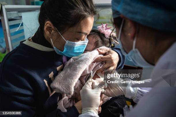 Child receives a vaccine against COVID-19 at a vaccination site on November 18, 2021 in Wuhan, China. Local adults who completed the second dose of...