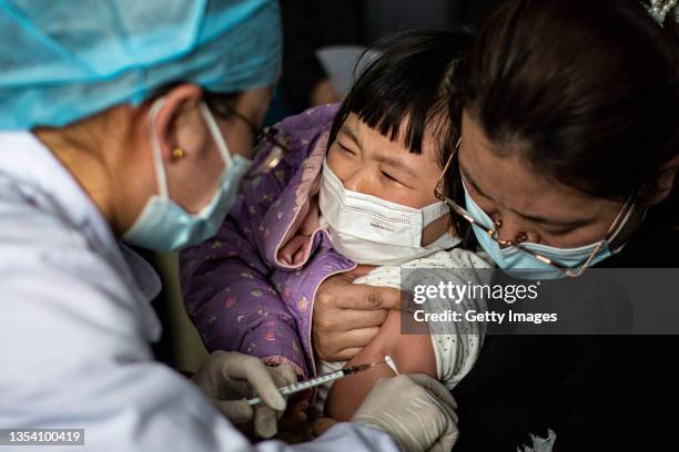 Child receives a vaccine against COVID-19 at a vaccination site on November 18, 2021 in Wuhan, China. Local adults who completed the second dose of...