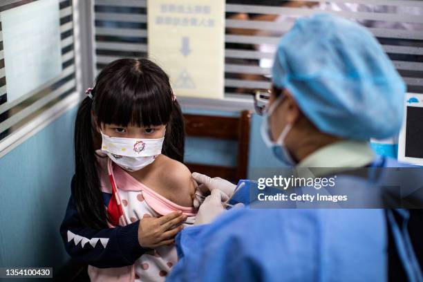Child receives a vaccine against COVID-19 at a vaccination site on November 18, 2021 in Wuhan, China. Local adults who completed the second dose of...