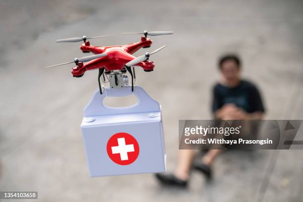 drones with first aid kits help people fall - unmanned aerial vehicle stock pictures, royalty-free photos & images