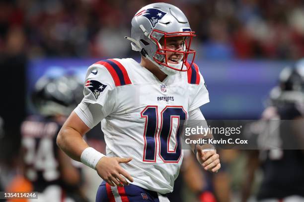 Mac Jones of the New England Patriots reacts after a touchdown agains the Atlanta Falcons in the second quarter at Mercedes-Benz Stadium on November...