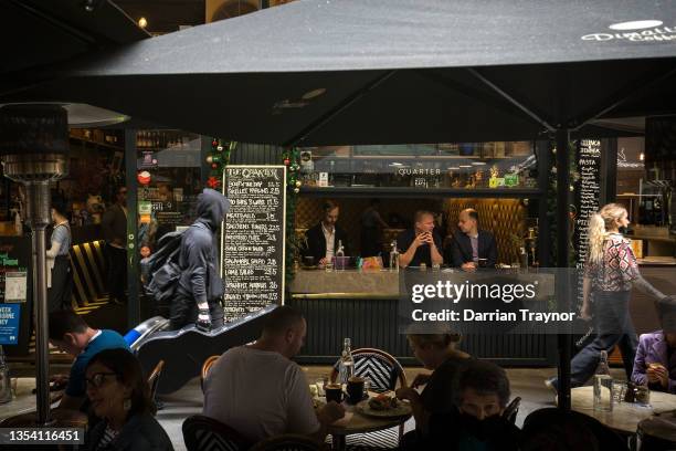 Busy cafes are seen in Degraves Street on November 19, 2021 in Melbourne, Australia. COVID-19 restrictions eased further with Victoria to reach its...
