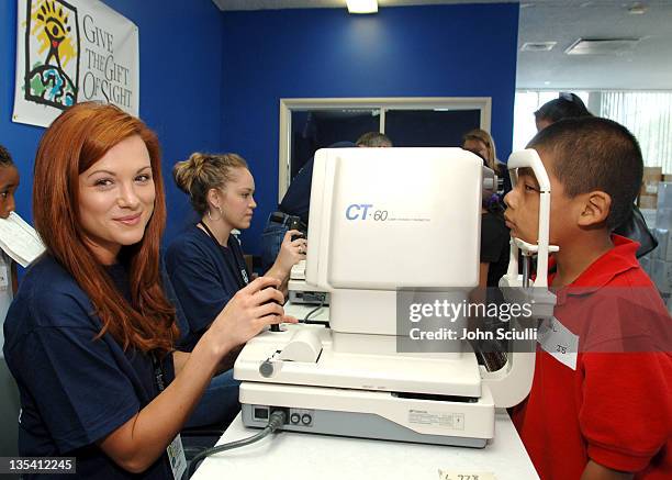 Danneel Harris performs exam at the NTT station during Danneel Harris Volunteers Her Time at The Gift of Sight Clinic in Downtown Los Angeles at...