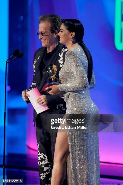 Emmanuel and Livia Brito speak onstage during The 22nd Annual Latin GRAMMY Awards at MGM Grand Garden Arena on November 18, 2021 in Las Vegas, Nevada.