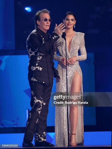 Emmanuel and Livia Brito speak onstage during The 22nd Annual Latin GRAMMY Awards at MGM Grand Garden Arena on November 18, 2021 in Las Vegas, Nevada.