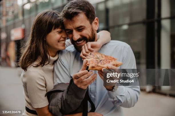 co workers sharing lunch - sharing pizza stock pictures, royalty-free photos & images