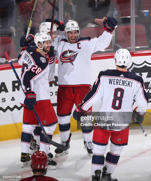 Boone Jenner, Oliver Bjorkstrand, and Yegor Chinakhov of the Columbus Blue Jackets celebrate after Zach Werenski scored a power-play goal against the...