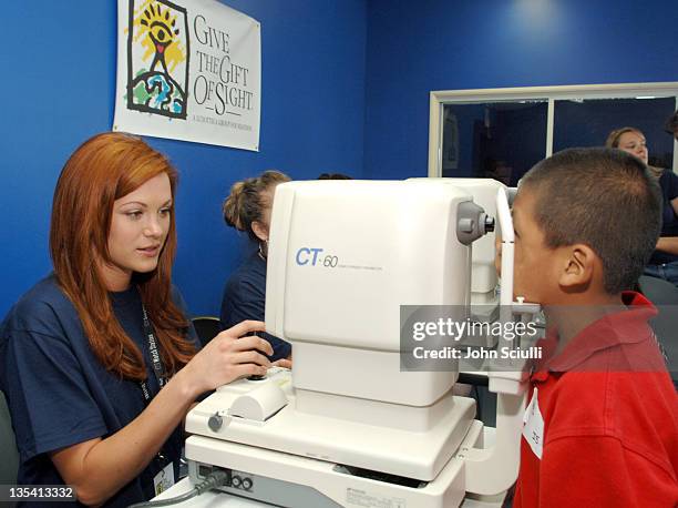 Danneel Harris performs exam at the NTT station during Danneel Harris Volunteers Her Time at The Gift of Sight Clinic in Downtown Los Angeles at...