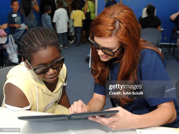 Danneel Harris performs the Randot Test during Danneel Harris Volunteers Her Time at The Gift of Sight Clinic in Downtown Los Angeles at United...