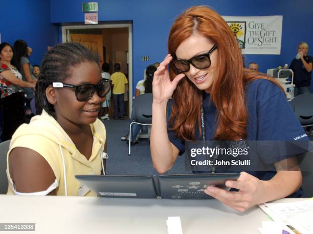 Danneel Harris performs the Randot Test during Danneel Harris Volunteers Her Time at The Gift of Sight Clinic in Downtown Los Angeles at United...