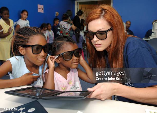 Danneel Harris performs the Randot Test during Danneel Harris Volunteers Her Time at The Gift of Sight Clinic in Downtown Los Angeles at United...