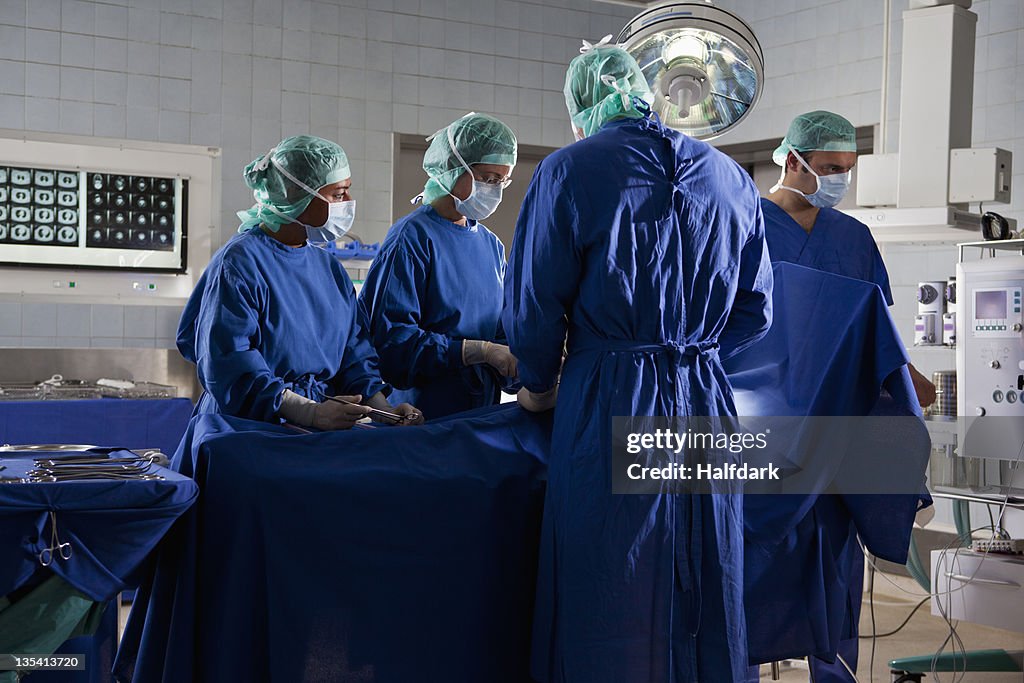 A surgery team operating on a patient in an operating room