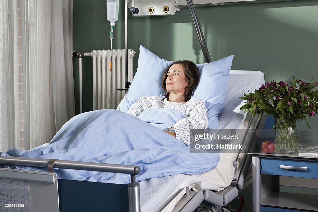 A woman lying in a hospital bed