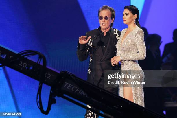 Emmanuel and Livia Brito speak onstage during The 22nd Annual Latin GRAMMY Awards at MGM Grand Garden Arena on November 18, 2021 in Las Vegas, Nevada.